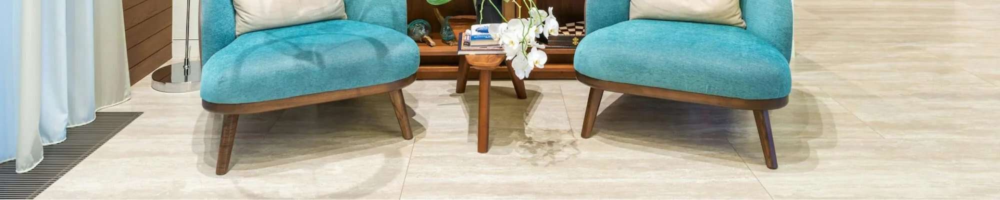 reading nook with blue chairs and wooden bookcase